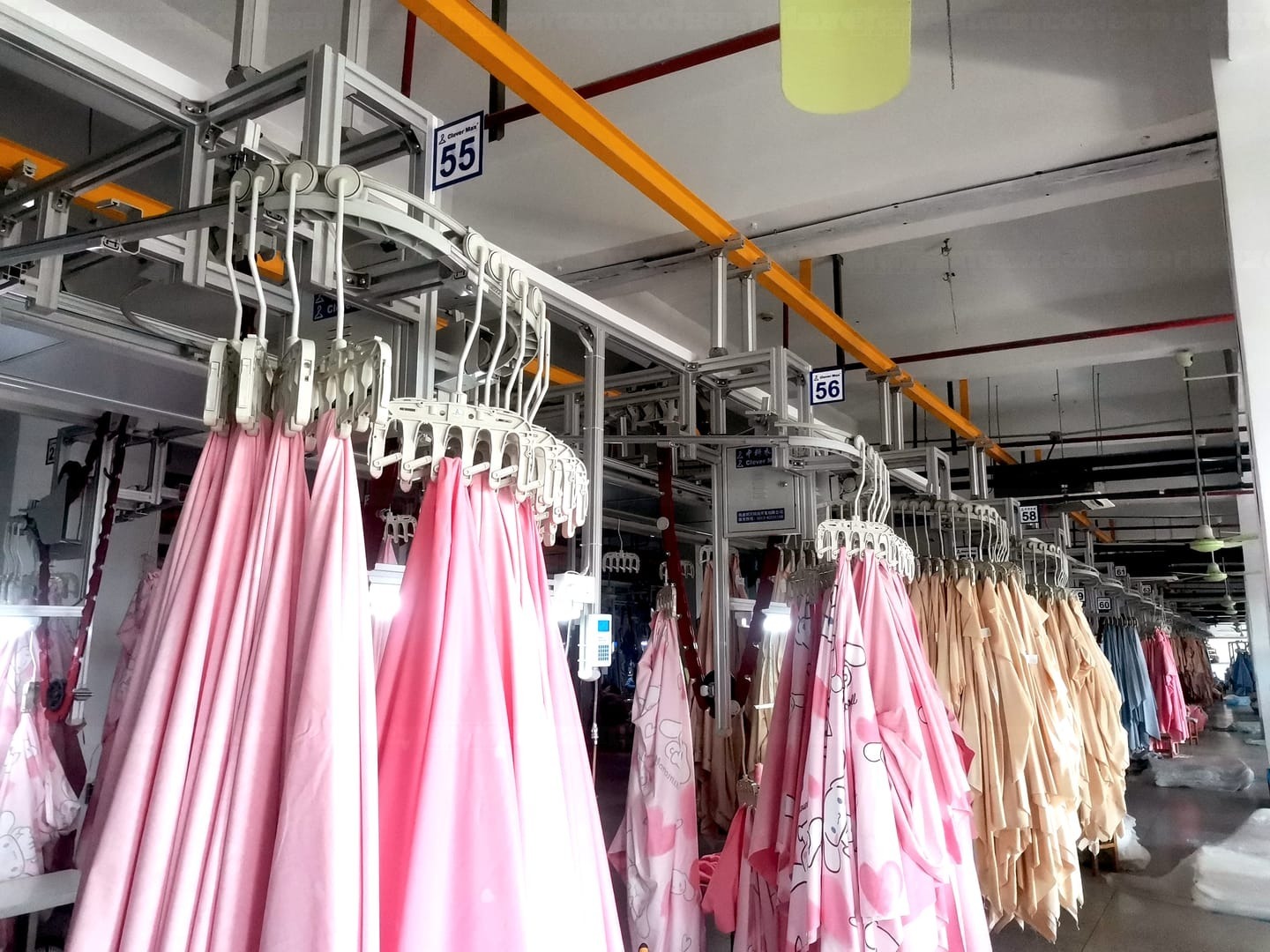 CleverMax Intelligent Warehousing System buffering garments on the hanger system overhead rail
